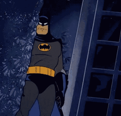a cartoon drawing of batman standing in front of a building
