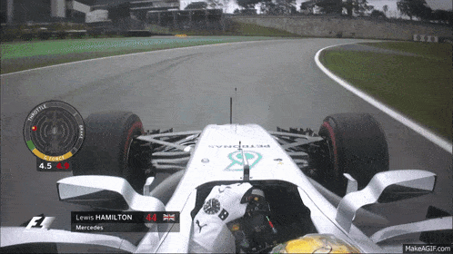 a lewis hamilton mercedes race car is driving down a track