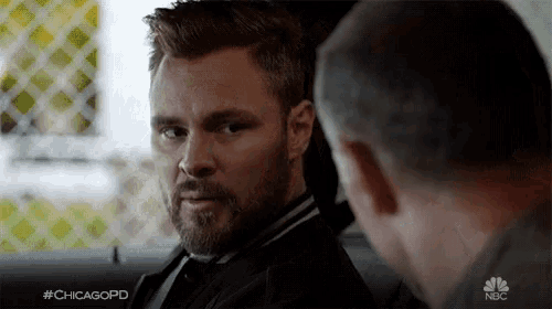 a man with a beard is talking to another man with #chicagopd on the bottom right