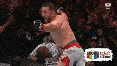 a man in a boxing ring with ufc gloves on