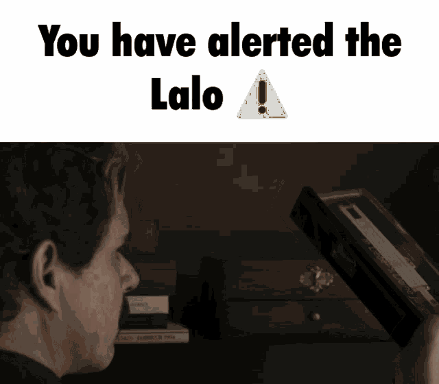 a man is looking at a box that says you have alerted the lalo on it