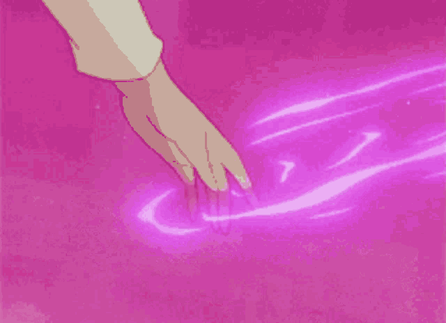 a person 's hand is touching a pink surface with a purple light coming out of it