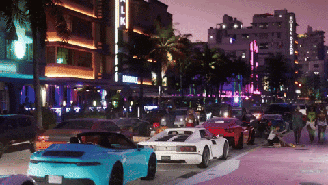 a blue sports car is parked in front of a hotel