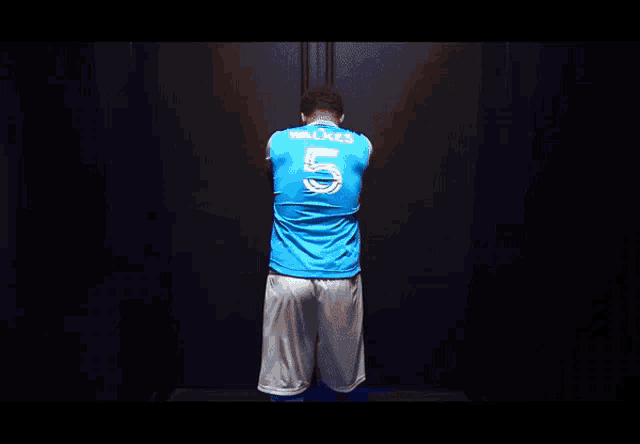 a man wearing a blue jersey that says walkes 5