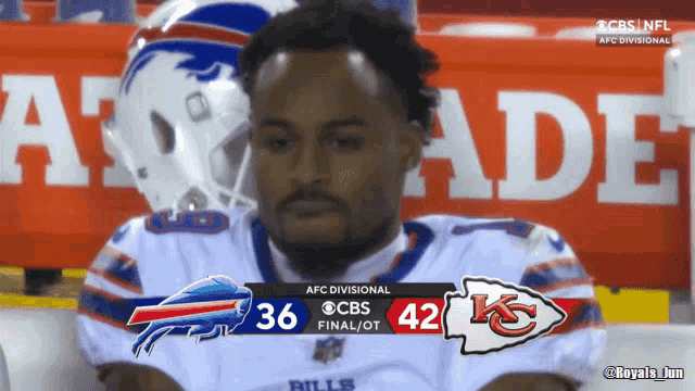 a buffalo bills player sits in front of a scoreboard that says 36-42