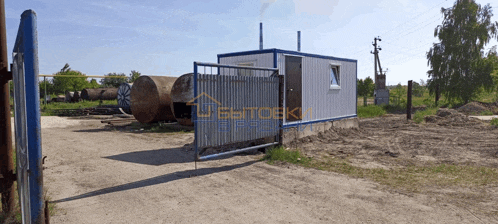 a white building with a blue fence and a sign that says webtoeki