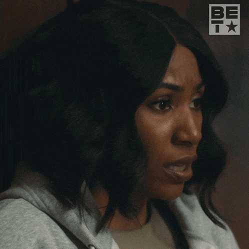 a close up of a woman 's face with the be t logo in the background
