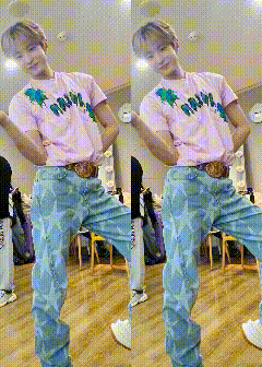 a man in a pink shirt and blue jeans is standing on one leg in a room