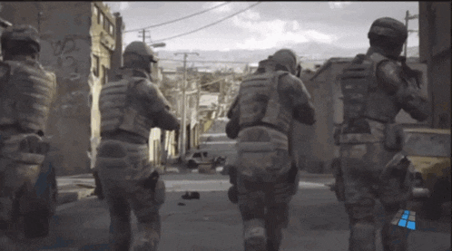 a group of soldiers are walking down a street with a blue arrow pointing to the right