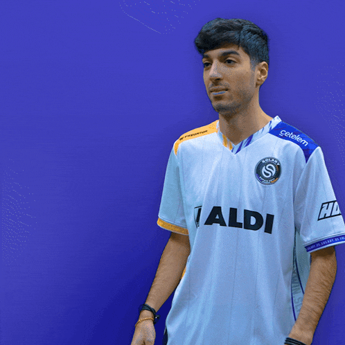 a man is wearing a white jersey with the name taxset on the back