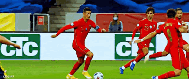 a group of soccer players are playing on a field with a banner that says jc on it