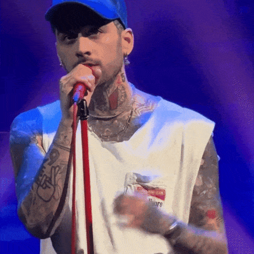 a man singing into a microphone while wearing a name tag that says ' marlboro '