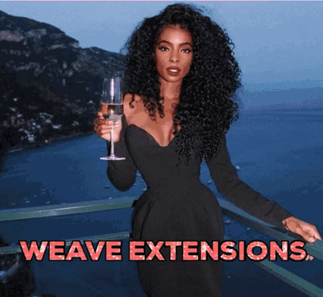 a woman in a black dress is holding a glass of wine with the words weave extensions written above her