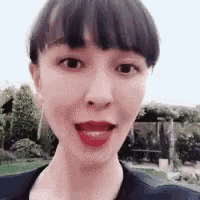 a close up of a woman 's face with her mouth open and her tongue sticking out .