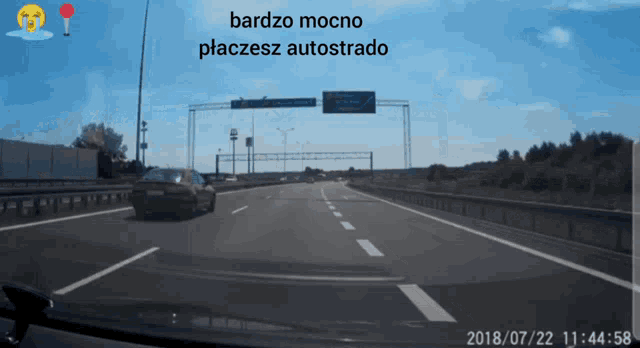 a car is driving down a highway with the words bardzo mocno placesz autostrado written above it
