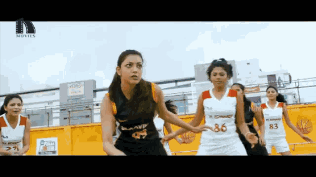 a group of women are playing basketball and one of them has the number 86 on her shirt