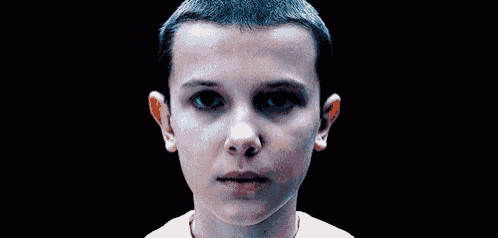 a close up of a young girl 's face with a surprised expression .