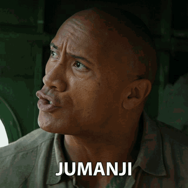 a close up of a man 's face with the word jumanji on the bottom right