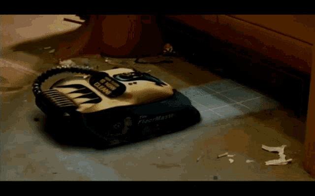 a vacuum cleaner is sitting on a tiled floor and the word pav is on the bottom right