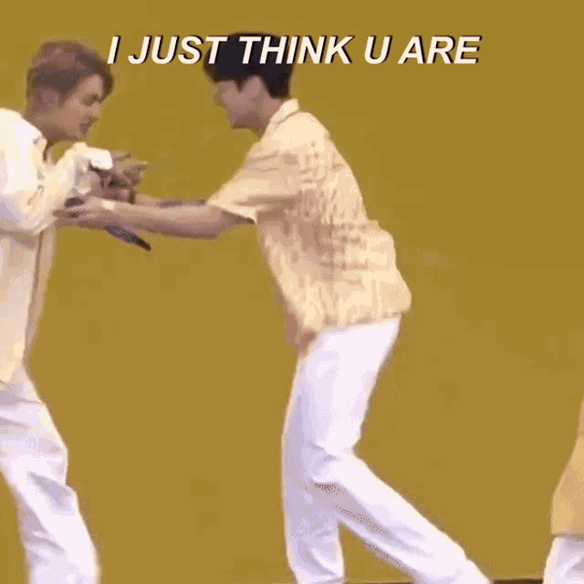two men standing next to each other with the words " i just think u are " on the top