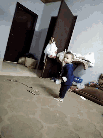 a person laying on a couch in a room with a bag of tissues on the floor