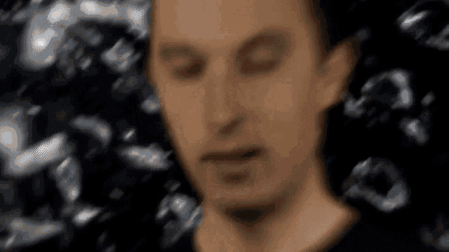 a blurry picture of a man with his eyes closed