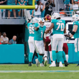 a group of football players are on a field with one wearing a number 70 jersey