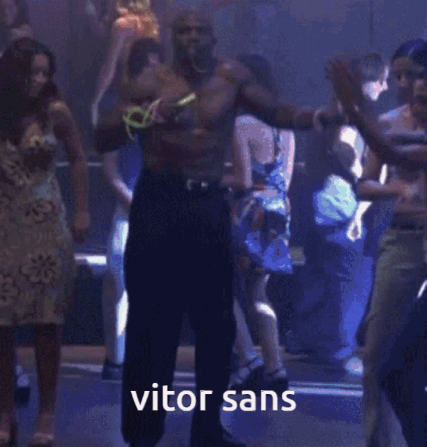 a man is dancing in front of a crowd with vitor sans written on the bottom of the image