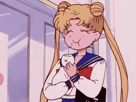 a girl in a school uniform is holding a tooth in her hands .