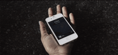 a hand is holding a phone that says drake on it