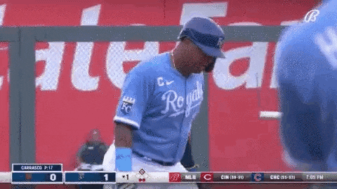 a baseball player wearing a royals jersey is standing on the field .