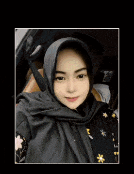 a woman wearing a hijab is sitting in a car with her eyes closed