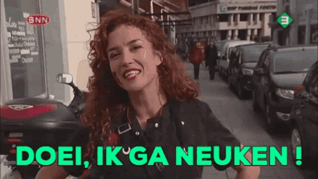 a woman with red hair is smiling with the words doei ik ga neuken below her