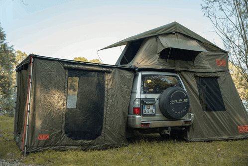 a toyota suv is parked next to a tent with a license plate that says bj st2 hl