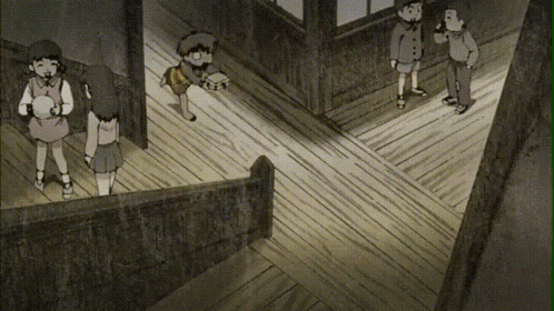 a group of children standing on a wooden floor in a hallway