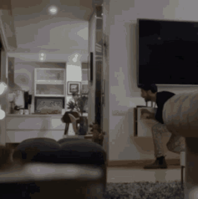 a man sits on a couch in front of a television