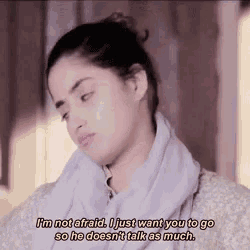 a woman with a scarf around her neck says i 'm not afraid