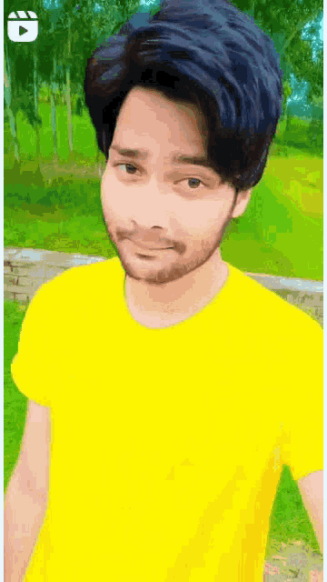a man wearing a yellow shirt is standing in a park