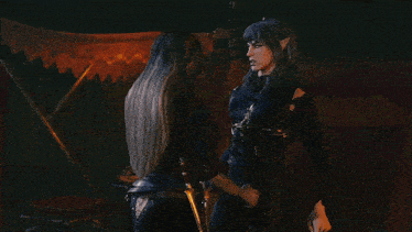 a woman with long gray hair is hugging a man in a black shirt