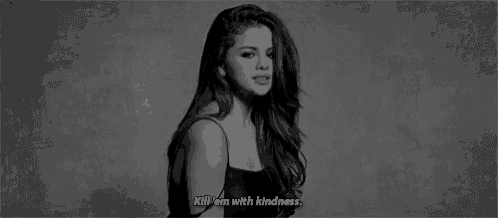 a black and white photo of a woman singing a song with the words `` kill 'em with kindness '' .