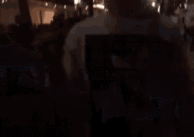 a person is holding a flashlight in their hand in a dark room .