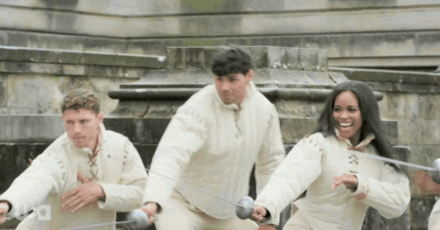 a group of people are holding swords with a usa logo in the corner