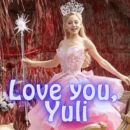 a woman in a pink dress holding a wand with the words love you yuli