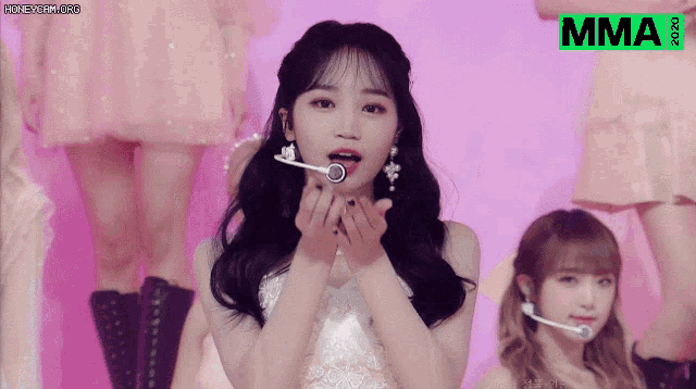 a girl blowing a kiss with the mma logo on the bottom