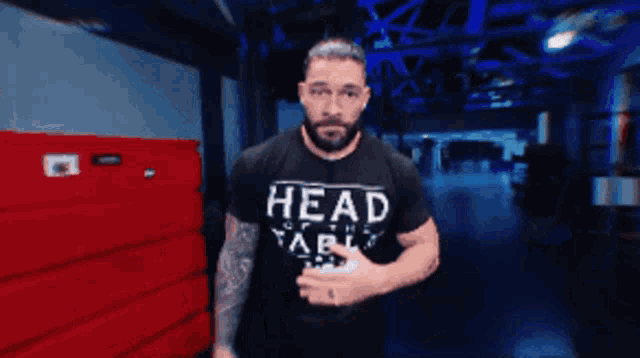 a man wearing a black shirt that says head on the table