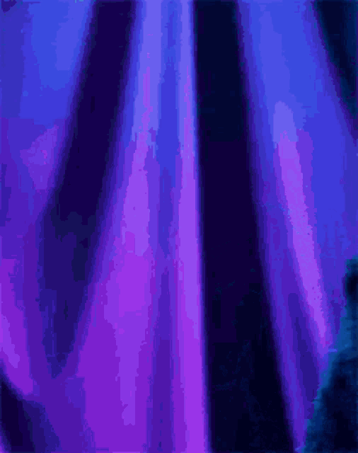 cookie monster is standing in front of a blue curtain