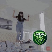 a woman is jumping in the air with a safu logo in the foreground