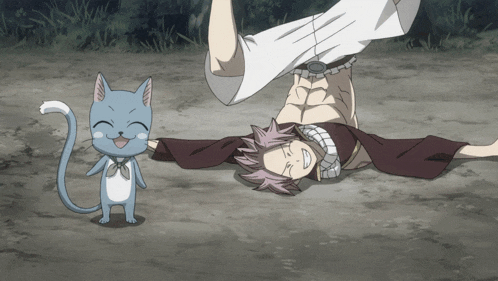a happy cat is standing next to a man who is laying on his back