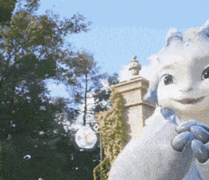 a statue of a rabbit is standing in front of a building and trees