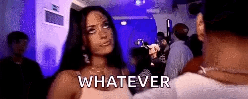 a woman is standing in a crowd at a party and says `` whatever '' .